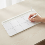 Hand holding the marker against the blank glass surface of the flat desk whiteboard