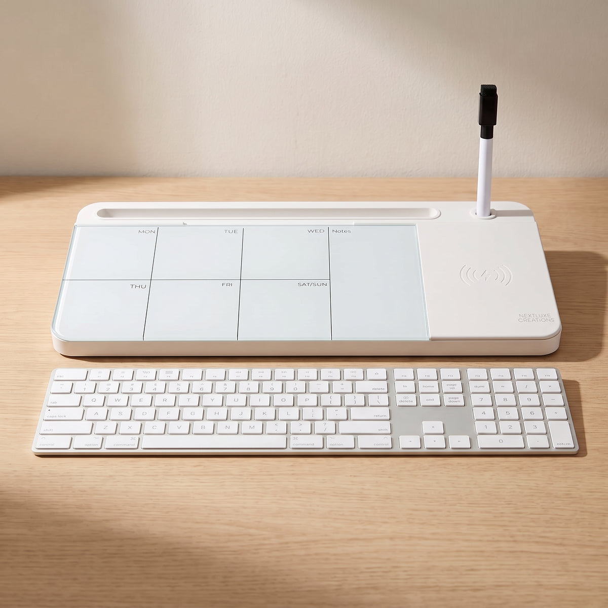 The whiteboard beside a full-size keyboard on the same desk, showing how wide it is