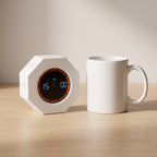 The timer side by side with a standard white ceramic coffee mug, showing it is about palm sized